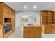 Spacious kitchen with a cooktop island, hardwood cabinets, and access to the dining area at 4018 Moon Lindley Rd, Snow Camp, NC 27349