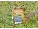 Aerial view of single-Gathering home surrounded by mature trees at 413 Correy Pl, Clayton, NC 27520