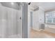 Bathroom with a separate shower and tub under a textured ceiling at 413 Correy Pl, Clayton, NC 27520