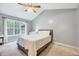 Serene bedroom with a large window providing natural light and a comfortable bed at 413 Correy Pl, Clayton, NC 27520