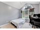 Cozy bedroom provides natural light from a large arched window and space for a computer desk at 413 Correy Pl, Clayton, NC 27520