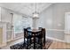 Dining area with a modern light fixture, table and chairs, and a view of the outdoor scenery at 413 Correy Pl, Clayton, NC 27520