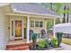 Close up of a cozy front porch with seating, brick steps, and a welcoming entrance to the home at 413 Correy Pl, Clayton, NC 27520