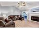 Spacious living room with hardwood floors, a cozy fireplace, and comfortable seating arrangement at 413 Correy Pl, Clayton, NC 27520