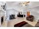 Open-concept living space featuring a fireplace, modern lighting, and seamless flow to other areas of the home at 413 Correy Pl, Clayton, NC 27520