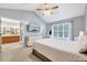Bright main bedroom features a vaulted ceiling with fan, television, and ensuite bathroom at 413 Correy Pl, Clayton, NC 27520