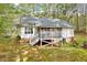 Exterior of home with screened porch, fire pit, and stairs leading to back door at 413 Correy Pl, Clayton, NC 27520