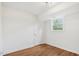 Basement space with wood floors, white walls, and a window at 4815 Oak Park Rd, Raleigh, NC 27612