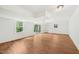 Basement with white walls, wood floors, 2 windows and sliding glass doors for natural light at 4815 Oak Park Rd, Raleigh, NC 27612