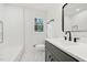 Modern bathroom with a tub, white subway tile, a gray vanity, and black hardware at 4815 Oak Park Rd, Raleigh, NC 27612