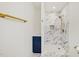 Luxurious bathroom showcasing an elegant glass shower with marble tile and a blue vanity with gold hardware at 4815 Oak Park Rd, Raleigh, NC 27612