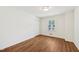 Empty bedroom boasts beautiful wood floors, a large window, and a spacious closet at 4815 Oak Park Rd, Raleigh, NC 27612
