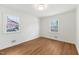 Bright bedroom with wood floors and two windows providing natural light at 4815 Oak Park Rd, Raleigh, NC 27612