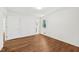 Bedroom with new floors, white walls, with ample light from windows and doors at 4815 Oak Park Rd, Raleigh, NC 27612