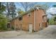 Two-story brick house with a driveway, white doors, and green foliage at 4815 Oak Park Rd, Raleigh, NC 27612