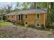 Charming brick home featuring a well-maintained yard and classic architectural details at 4815 Oak Park Rd, Raleigh, NC 27612