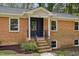 Inviting front entrance showcasing a brick facade, stylish front door, and manicured landscaping at 4815 Oak Park Rd, Raleigh, NC 27612