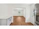 Hallway leading into a living room with an open doorway and views of the front yard at 4815 Oak Park Rd, Raleigh, NC 27612