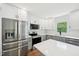 Bright kitchen featuring stainless steel appliances, modern cabinets, and a tiled backsplash at 4815 Oak Park Rd, Raleigh, NC 27612