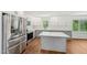 Well-lit kitchen with stainless steel appliances and gray and white cabinets at 4815 Oak Park Rd, Raleigh, NC 27612