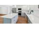 Modern kitchen with white cabinets, stainless steel appliances, and a large island at 4815 Oak Park Rd, Raleigh, NC 27612