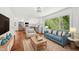 Inviting living room with an open kitchen layout and views of the outdoors at 4815 Oak Park Rd, Raleigh, NC 27612