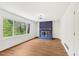 Bright living room featuring a blue brick fireplace and large window with natural light at 4815 Oak Park Rd, Raleigh, NC 27612
