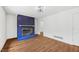 Spacious living room with a brick fireplace and a large window for natural light at 4815 Oak Park Rd, Raleigh, NC 27612