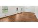 Bright and airy living room featuring hardwood floors, large windows, and ample natural light at 4815 Oak Park Rd, Raleigh, NC 27612