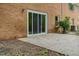 Brick house featuring a concrete patio and sliding glass doors at 4815 Oak Park Rd, Raleigh, NC 27612