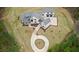 Beautiful aerial view of a white farmhouse with a circular driveway and well-maintained landscaping at 482 Emily Ln, Chapel Hill, NC 27516