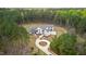 Stunning aerial view of a modern farmhouse with a circular driveway nestled in a lush forest setting at 482 Emily Ln, Chapel Hill, NC 27516