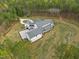 A modern white farmhouse with a gray roof, surrounded by a circular driveway and green lawn at 482 Emily Ln, Chapel Hill, NC 27516