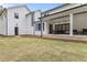 Backyard with a covered patio, chairs, and an expansive lawn for outdoor activities at 482 Emily Ln, Chapel Hill, NC 27516