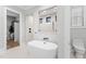 Bright bathroom featuring a modern standalone tub and a glimpse into the tiled shower at 482 Emily Ln, Chapel Hill, NC 27516