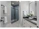 Modern bathroom with gray tiled shower, sleek vanity, and stylish black hardware accents at 482 Emily Ln, Chapel Hill, NC 27516