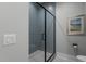 Bathroom featuring gray tiled shower with glass door and a modern toilet at 482 Emily Ln, Chapel Hill, NC 27516