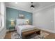Cozy bedroom featuring a ceiling fan, a large window, and hardwood floors at 482 Emily Ln, Chapel Hill, NC 27516
