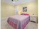 Bright bedroom with yellow walls, carpet, and a cozy queen bed with pink accents at 482 Emily Ln, Chapel Hill, NC 27516