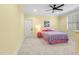 Cheerful bedroom with yellow walls, carpet, and a queen bed with pink and purple bedding at 482 Emily Ln, Chapel Hill, NC 27516