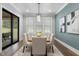 Dining room features a modern chandelier, wooden table, six chairs, and sliding glass door at 482 Emily Ln, Chapel Hill, NC 27516