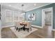 Dining room features a modern chandelier, wooden table, six chairs, and large windows at 482 Emily Ln, Chapel Hill, NC 27516
