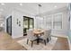 Dining room features a modern chandelier, wooden table, six chairs, and sliding glass door at 482 Emily Ln, Chapel Hill, NC 27516