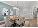 Dining room features a modern chandelier, wooden table, six chairs, and decorative paintings at 482 Emily Ln, Chapel Hill, NC 27516
