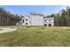 Modern farmhouse with large lawn, black window trim and breezeway connecting garages at 482 Emily Ln, Chapel Hill, NC 27516