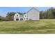 Modern farmhouse exterior showing white board and batten siding, black trim and sprawling lawn at 482 Emily Ln, Chapel Hill, NC 27516