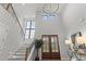 Soaring foyer with double doors, hardwood floors, staircase, and statement lighting at 482 Emily Ln, Chapel Hill, NC 27516
