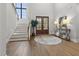 Grand foyer with hardwood floors, double doors, statement lighting, and staircase at 482 Emily Ln, Chapel Hill, NC 27516