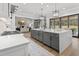 Open kitchen featuring gray island, quartz countertops, stainless steel appliances, and hardwood floors at 482 Emily Ln, Chapel Hill, NC 27516