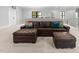 Relaxing living room featuring a large brown leather sectional and comfortable ottoman at 482 Emily Ln, Chapel Hill, NC 27516
